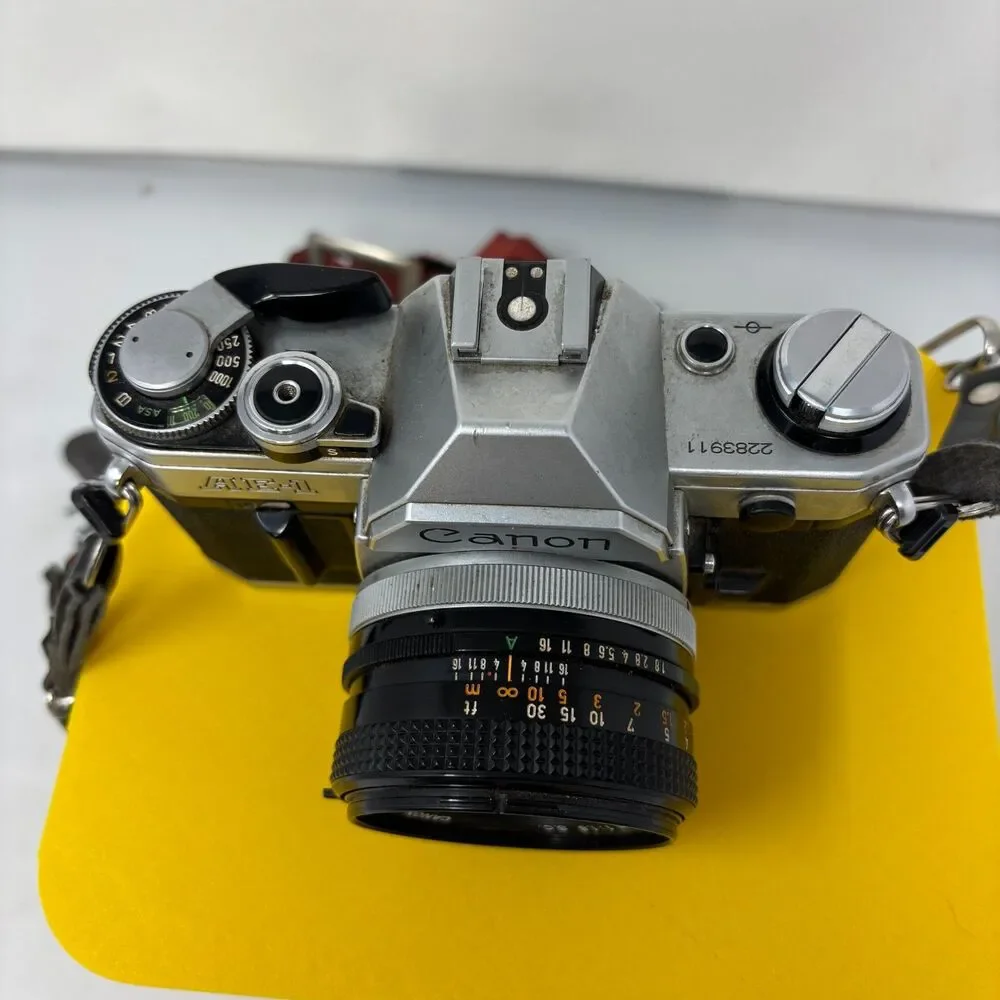 Canon AE-1 35mm SLR Film Camera W/ 2 Lens, Flash, Case, Paperwork UNTESTED
